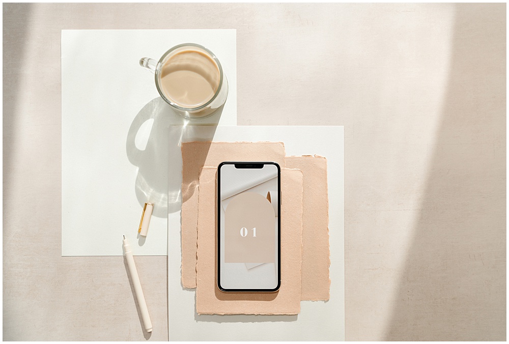 flat lay of cell phone with habit tracking app, to do list, cup of coffee