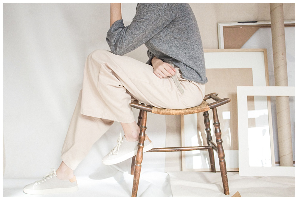 take a break when in a creative rut - woman sitting on stool surrounded by art supplies