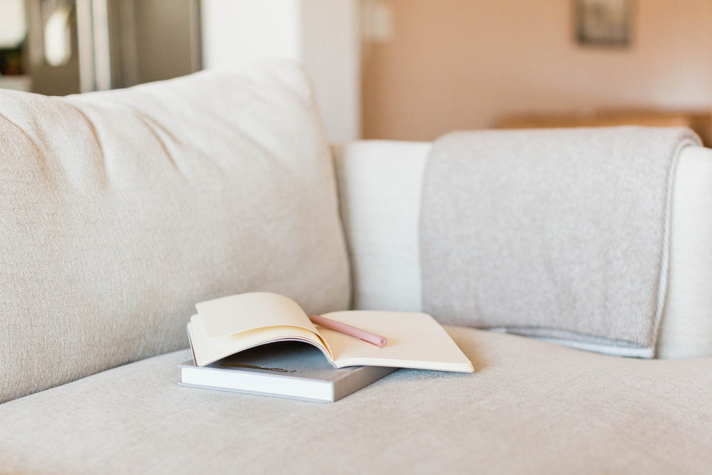 notebook sitting on couch with ideas of How to Keep Connections with Friends and Family Outside of Social Media 