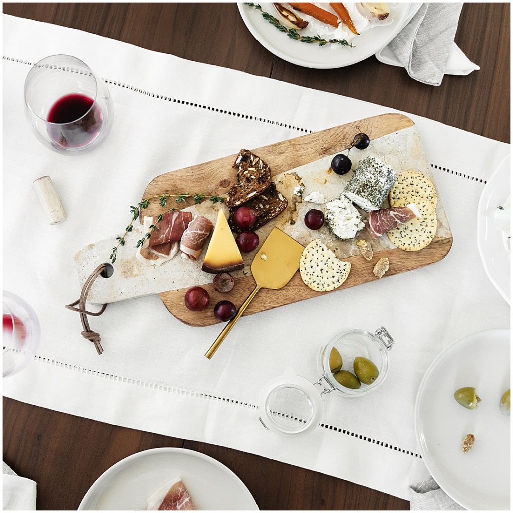 14 At Home Date Ideas - snack board night with a charcuterie board with cheese, crackers, grapes, and prosciutto 